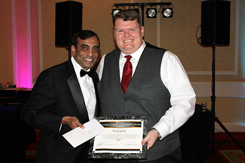 [ photo: SSAI's Anoop Mehta presenting award to Brent Smith ]
